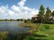 Scenic view of the tranquil pond and surrounding landscaping; the perfect place for relaxation and reflection at 4949 Savona Run, Bradenton, FL 34211