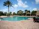 Resort-style pool area features ample seating, lush landscaping, and a relaxing atmosphere for residents to enjoy at 4949 Savona Run, Bradenton, FL 34211