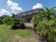 Enclosed patio featuring tropical landscaping for an outdoor oasis at 4949 Savona Run, Bradenton, FL 34211
