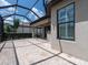 Inviting covered patio with stone flooring, ceiling fan, and view to the backyard at 4949 Savona Run, Bradenton, FL 34211
