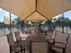 The seating area has tables, chairs, and overhead shade at 4949 Savona Run, Bradenton, FL 34211