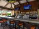 Stylish tiki bar with ample seating, multiple TVs, and a wide selection of beverages at 4949 Savona Run, Bradenton, FL 34211