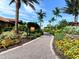 Scenic walkway leading to the tiki bar, surrounded by beautiful landscaping and vibrant flowers at 4949 Savona Run, Bradenton, FL 34211