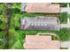 An aerial view reveals the backyard, including the screened in patio and adjacent landscaping at 5117 Serata Dr, Bradenton, FL 34211