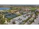 Community aerial view showcasing tennis courts, parking, clubhouse and other amenities by a lake at 5117 Serata Dr, Bradenton, FL 34211