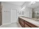 Bright bathroom with double vanity, large mirror, and walk-in shower provides a spa-like experience at 5117 Serata Dr, Bradenton, FL 34211