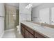 Stylish bathroom with glass-enclosed shower, double vanity and ample countertop space at 5117 Serata Dr, Bradenton, FL 34211