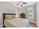 Comfortable bedroom features a plush bed, ceiling fan, and natural light, offering a relaxing retreat at 5117 Serata Dr, Bradenton, FL 34211