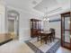 Traditional dining room features a coffered ceiling, a formal dining table and a decorative china cabinet at 5117 Serata Dr, Bradenton, FL 34211