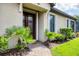Inviting front entrance featuring a glass-paneled double door and manicured landscaping at 5117 Serata Dr, Bradenton, FL 34211
