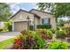 Beautiful home featuring lush landscaping, an inviting exterior, and a paved driveway at 5117 Serata Dr, Bradenton, FL 34211