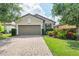 Charming single-story home with a well-kept lawn and a paved driveway leading to the garage at 5117 Serata Dr, Bradenton, FL 34211
