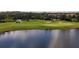 Picturesque golf course by the lake featuring lush greens, a sand trap, and golf carts in the distance at 5117 Serata Dr, Bradenton, FL 34211