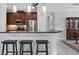 A kitchen bar features dark cabinets and stainless steel appliances with modern pendant lighting at 5117 Serata Dr, Bradenton, FL 34211
