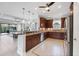 Spacious kitchen features stainless steel appliances, dark cabinets, and tiled floors with a breakfast bar at 5117 Serata Dr, Bradenton, FL 34211