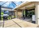 The screened-in lanai includes a dining area and outdoor cooking space, great for entertaining at 5117 Serata Dr, Bradenton, FL 34211