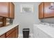 Functional laundry room with washer, dryer, cabinets and counter for efficient laundry care at 5117 Serata Dr, Bradenton, FL 34211