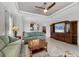 Relaxing living room featuring tile flooring, a ceiling fan, and open to dining area at 5117 Serata Dr, Bradenton, FL 34211