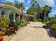 Paver patio lined with lush tropical landscaping at 5207 86Th Street W Ct, Bradenton, FL 34210
