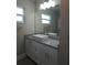 Modern bathroom featuring a granite countertop vanity with white cabinets at 5207 86Th Street W Ct, Bradenton, FL 34210
