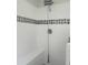 Shower featuring tiled walls, a shower head, and a built-in bench at 5207 86Th Street W Ct, Bradenton, FL 34210
