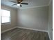 Bedroom with ceiling fan, window, and laminate flooring at 5207 86Th Street W Ct, Bradenton, FL 34210