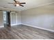 Spacious bedroom with wood look floors, ceiling fan, and sliding door at 5207 86Th Street W Ct, Bradenton, FL 34210