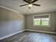 Bedroom features include laminate flooring, ceiling fan, neutral paint, and a large window at 5207 86Th Street W Ct, Bradenton, FL 34210