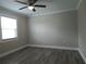 Empty bedroom featuring hardwood floors, a ceiling fan, and a large window at 5207 86Th Street W Ct, Bradenton, FL 34210