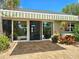 Exterior patio with awning, large glass doors, and tropical plants at 5207 86Th Street W Ct, Bradenton, FL 34210