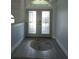 Charming entryway featuring decorative glass double doors, stylish rug, and light gray walls at 5207 86Th Street W Ct, Bradenton, FL 34210