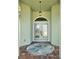 Inviting front entry with double doors, transom window, and decorative hanging light fixture at 5207 86Th Street W Ct, Bradenton, FL 34210