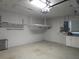 Clean garage with storage racks, work bench and white cabinets at 5207 86Th Street W Ct, Bradenton, FL 34210