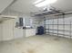 Bright garage equipped with storage racks, work bench, white cabinets and garage door opener at 5207 86Th Street W Ct, Bradenton, FL 34210
