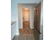 This hallway features wood floors and neutral paint, connecting the kitchen to a laundry area at 5207 86Th Street W Ct, Bradenton, FL 34210