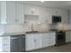 Well-lit kitchen featuring white cabinets, granite countertops, stainless steel appliances, and subway tile at 5207 86Th Street W Ct, Bradenton, FL 34210