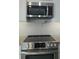 Modern kitchen showcasing stainless steel appliances, granite countertops, and a tile backsplash at 5207 86Th Street W Ct, Bradenton, FL 34210