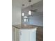 Bright kitchen with granite countertop, white cabinetry, and pendant lighting overlooking the living area at 5207 86Th Street W Ct, Bradenton, FL 34210