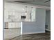 Open kitchen view showing white cabinets, granite countertops, stainless appliances and modern pendant lights at 5207 86Th Street W Ct, Bradenton, FL 34210