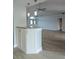 Open kitchen with granite countertop, white cabinets, modern lighting, and views to the living room at 5207 86Th Street W Ct, Bradenton, FL 34210