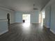 Spacious living room with new flooring, ceiling fan and sliding glass doors at 5207 86Th Street W Ct, Bradenton, FL 34210