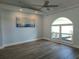 Bright room with large window, ceiling fan, and neutral flooring, perfect for relaxing or entertaining at 5207 86Th Street W Ct, Bradenton, FL 34210