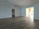 Open and airy living room showcasing wood floors, light blue walls, and access to multiple rooms at 5207 86Th Street W Ct, Bradenton, FL 34210