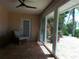 Cozy sunroom with tile floors, a wicker chair, and sliding glass doors to the patio at 5207 86Th Street W Ct, Bradenton, FL 34210