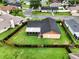 Aerial view shows home's fenced backyard, fire pit, and screened-in patio at 5433 81St Avenue E Cir, Palmetto, FL 34221