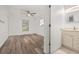 Bathroom featuring tile flooring, single sink vanity, window, and a step-in shower with tan tile at 5433 81St Avenue E Cir, Palmetto, FL 34221