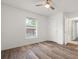 Bedroom featuring sleek floors, a ceiling fan, and a window with natural light at 5433 81St Avenue E Cir, Palmetto, FL 34221