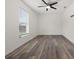 Bedroom featuring sleek floors, a ceiling fan, and a window with natural light at 5433 81St Avenue E Cir, Palmetto, FL 34221