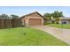 Home exterior featuring a well-manicured lawn, brick driveway and attached two-car garage at 5433 81St Avenue E Cir, Palmetto, FL 34221