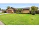 Exterior view of a home features a lush lawn, mature landscaping and an attached garage at 5433 81St Avenue E Cir, Palmetto, FL 34221
